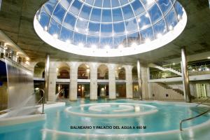 a pool in a building with a glass dome at Balnea O Pazo in Mondariz-Balneario