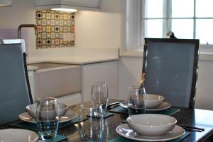 una mesa con platos y vasos encima en Aqua Vista- seafront cottage Cellardyke en Anstruther