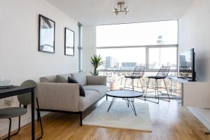 a living room with a couch and a table and chairs at Skyline Views Free Parking Near Dale Street in Liverpool