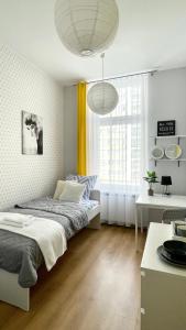 a bedroom with a bed and a large window at Beautiful rooms in the center in Szczecin