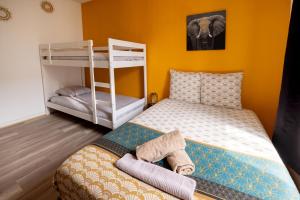 Posteľ alebo postele v izbe v ubytovaní LD-Location Hôtel