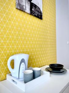 a kitchen counter with a toaster and two cups at Beautiful rooms in the center in Szczecin