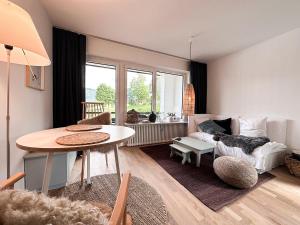 sala de estar con mesa y sofá en Eisvogel, en Oberstaufen