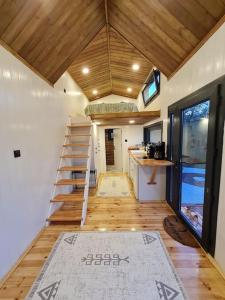 a small room with a staircase in a tiny house at Antik Tiny House in İznik