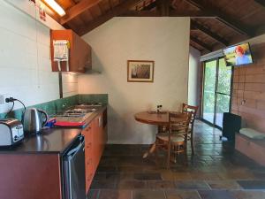 a kitchen with a table and a counter top at The Bushranger Hideaway in Midginbil