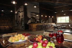 a table topped with plates of fruit and wine glasses at Glamping Eco Valley in Shahumyan