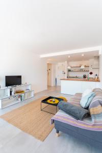 a living room with a couch and a table at SUNSET1 - By Smarthomes in São Martinho do Porto