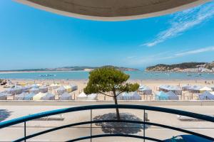 a view of the beach from the balcony of a resort at SUNSET1 - By Smarthomes in São Martinho do Porto