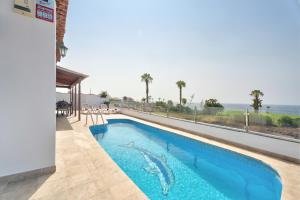 a swimming pool with a view of the ocean at Villa Atlantico in San Miguel de Abona