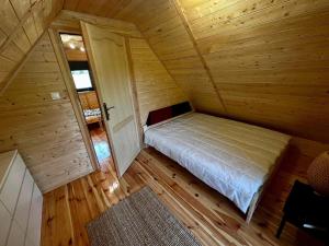 an overhead view of a bedroom in a log cabin at Domek letniskowy Aster z basenem i jacuzzi in Małdyty