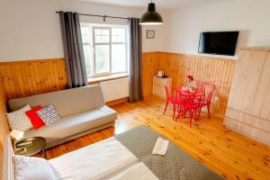 a living room with a couch and a table at Dom, Pokoje, Kwatery Prywatne Przy Rzeźbie Rybaka in Rowy