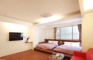 A bed or beds in a room at Shang Ti Sitou B&B