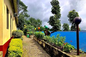 a garden with some plants and a blue wall at New Araniko Resort (P) Ltd in Chautara