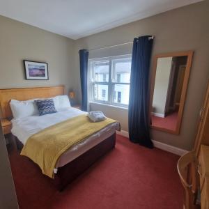 a bedroom with a bed and a large window at West View Accomodation in Louisburgh