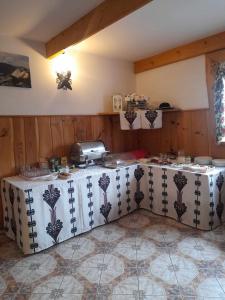 a kitchen with a table with a counter top at Nad Potokiem in Poronin