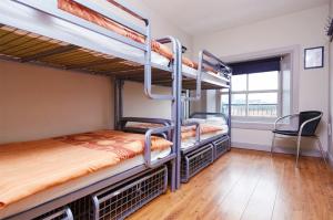 two bunk beds in a room with a window at Bru Bar & Hostel in Cork