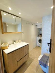 a bathroom with a sink and a washing machine at Avramiou Loft Studio in Ágios Rókkos