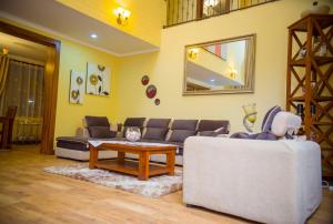 a living room with a couch and a table at Cornerstone Villas in Arusha