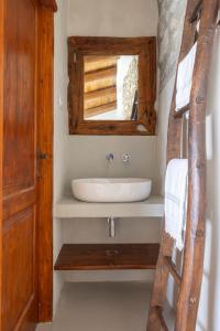 a bathroom with a sink and a mirror at Donna Rina - suggestiva casa nel centro storico in Colledimezzo