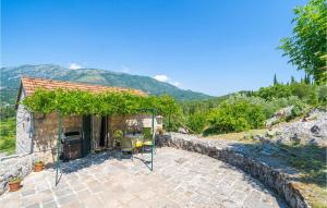 a house with a patio with a bunch of vines at Beautiful Home In Gruda With Wifi in Gruda +12 photos