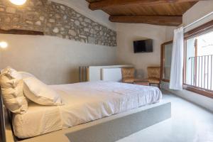 um quarto com uma cama grande e uma janela em Donna Rina - suggestiva casa nel centro storico em Colledimezzo