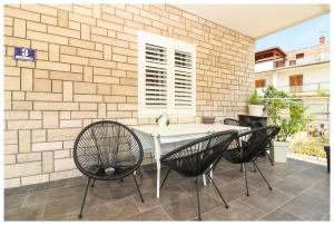 a white table and chairs on a patio at Apartment Ballin in Primošten