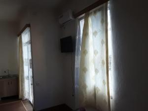 TV o dispositivi per l'intrattenimento presso Guest House Buche 219