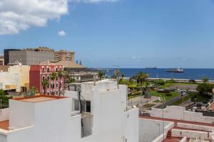 a view of the ocean from a building at Vegueta Luxury Apartments in Las Palmas de Gran Canaria
