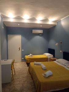 pokój hotelowy z 2 łóżkami i drzwiami w obiekcie Affittacamere Novoli we Florencji
