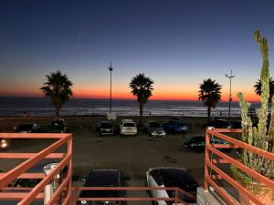 a parking lot at the beach with cars parked at Blue Apartment in Gonio