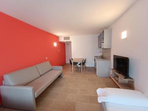 a living room with a couch and a tv at Apartamentos Turísticos Pontepedriña by Bossh! Hotels in Santiago de Compostela