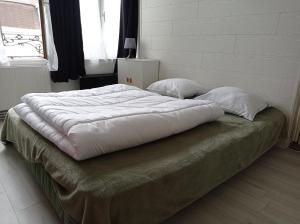 a large bed with two pillows on top of it at L'Opale 3, studio 2 pers in Berck-sur-Mer
