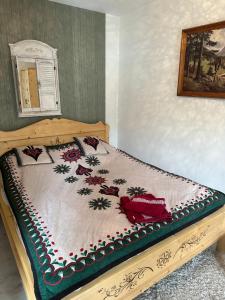a bed in a bedroom with a bedspread on it at KONWALIA in Zakopane
