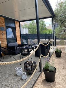 a patio with a rope and chairs and plants at INNOVA TravelVir Mobhome Eli in Sveti Petar