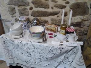 a table with a tea set on top of it at La Chevallerie - Tranquil oasis in Isigny-le-Buat