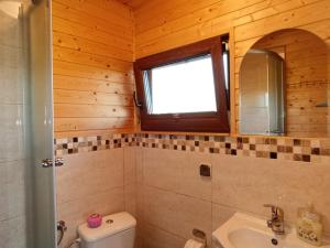 a bathroom with a toilet and a sink and a window at Wypoczynek nad stawami in Sobiechy +18 photos