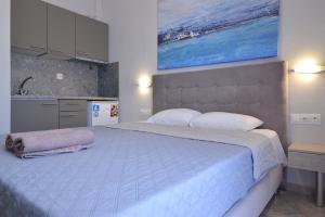 a bedroom with a large bed and a painting on the wall at Villa Matina in Leptokaria