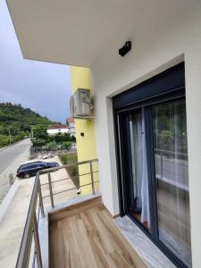 - un balcon d'un bâtiment avec une grande porte en verre dans l'établissement Unique, à Gramsh