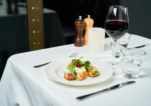 a table with a plate of food and a glass of wine at Viking Line ferry Viking Cinderella - Cruise Stockholm-Helsinki-Stockholm in Stockholm