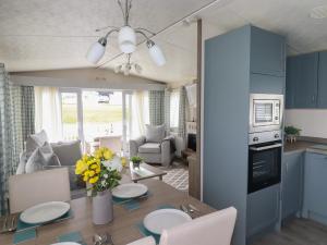 a kitchen and dining room with a table and chairs at No 4 Fistral in Newquay