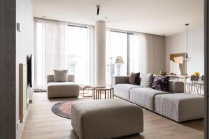 a living room with a couch and a chair at 348 Suites Short Stay in The Hague