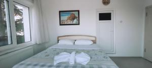 a bedroom with a bed with a bow tie on it at Phoenix Inn Cappadocia in Nevşehir