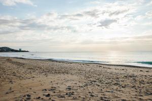 a sandy beach with the ocean in the background at Alannia Costa Dorada in Platja de l’Almadrava