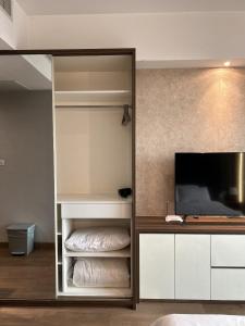 a bedroom with a bunk bed and a television at U Residence 2 Studio Apartment POOL VIEW in Tangerang