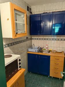 a kitchen with blue cabinets and a sink at Zlatiborski Kutak in Zlatibor