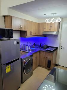 a kitchen with a stainless steel refrigerator and a dishwasher at Juja's place in Manila