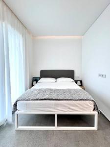a white bedroom with a bed in a room at ALC1 Ampio appartamento 4 persone in San Giovanni in Marignano