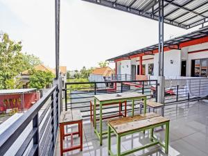 d'une terrasse sur le toit avec des tables et des chaises. dans l'établissement OYO 92736 Bougenville Rover, à Lamongan