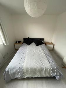 a bedroom with a bed with a white comforter at 2BD Flat with Views of Canary Wharf - Rotherhithe in London