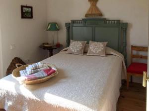 a bedroom with a large bed with a basket on it at CASA PALACIO PRIVADO EN CADIZ CAPITAL - by Andalusian Glory in Cádiz
